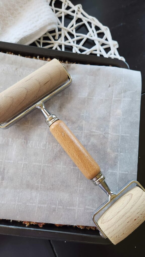 roller over a baking sheet that rolled flax seed bars