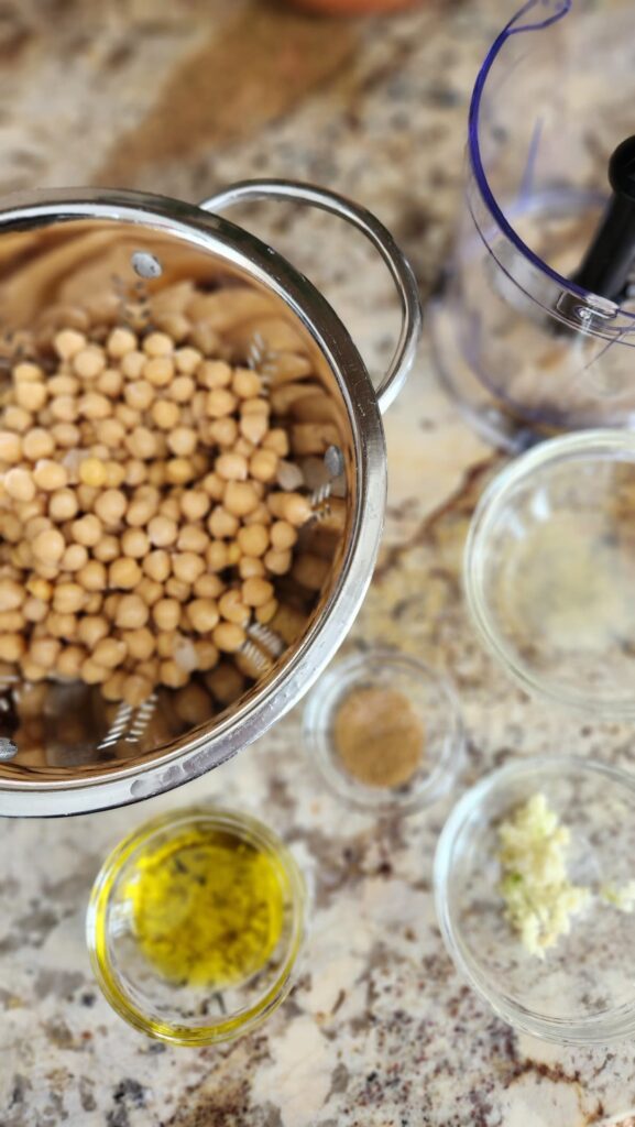 overhead of silver colander with chick peas in it