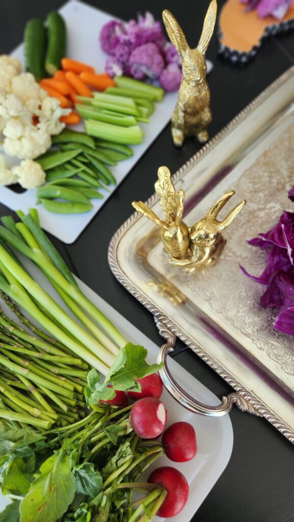 silver tray with two gold bunnies and sliced vegetables