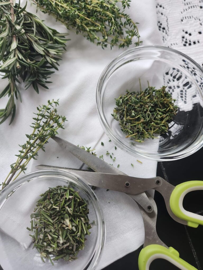 fresh rosemary and thyme in glass bowl for gluten free crispbread recipe