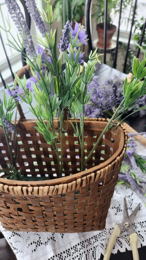 lavender stems being placed inside wicker basket