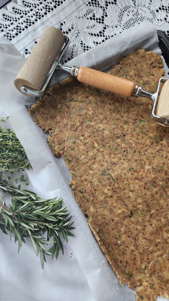 roller rolling crispbread on to baking sheet