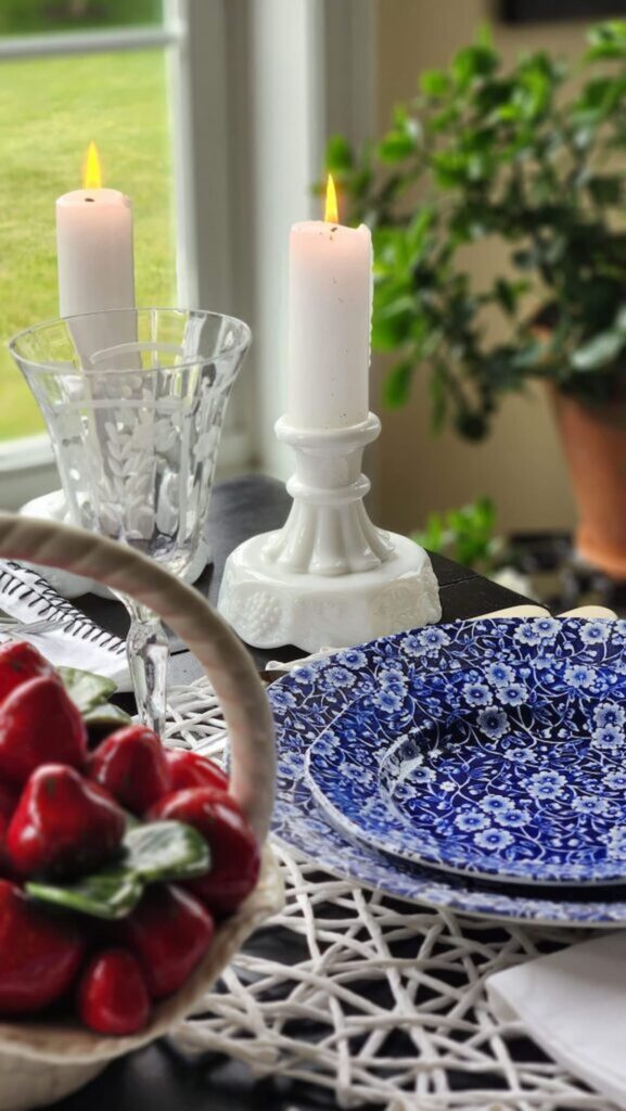 two vintage milk glass candleholders on red white and blue table