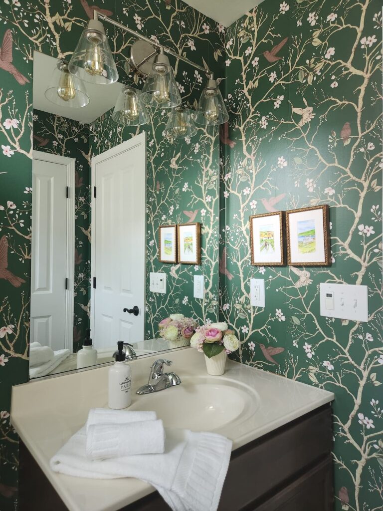 wallpaper bathroom with framed art on wall
