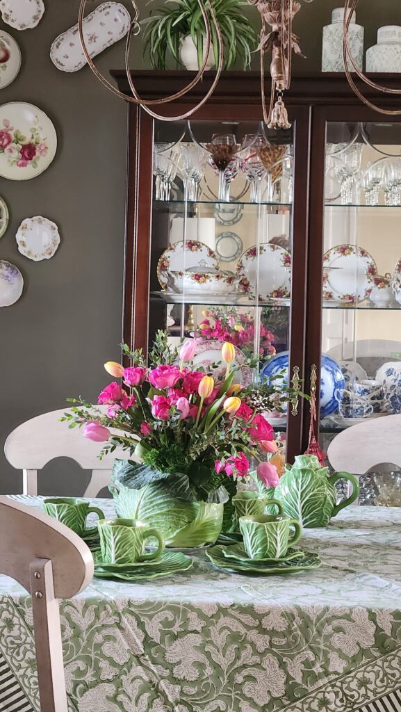 cabbage arrangement with roses and tulips on dining room table
