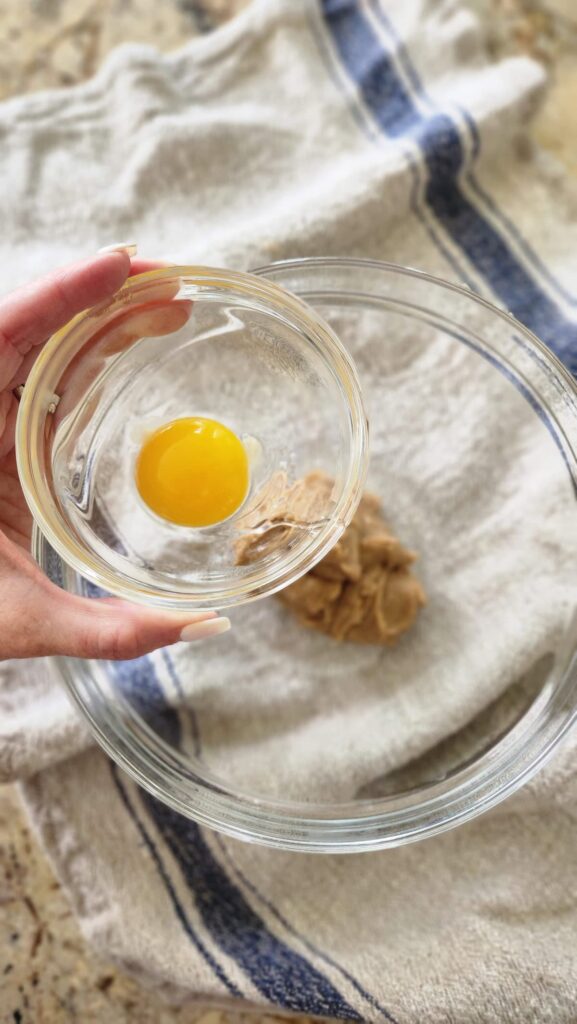 egg yolk in glass bowl to be added to mixture