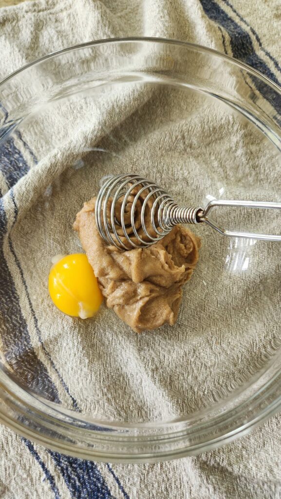 egg yolk in bowl to be mixed with creamed sugar and butter