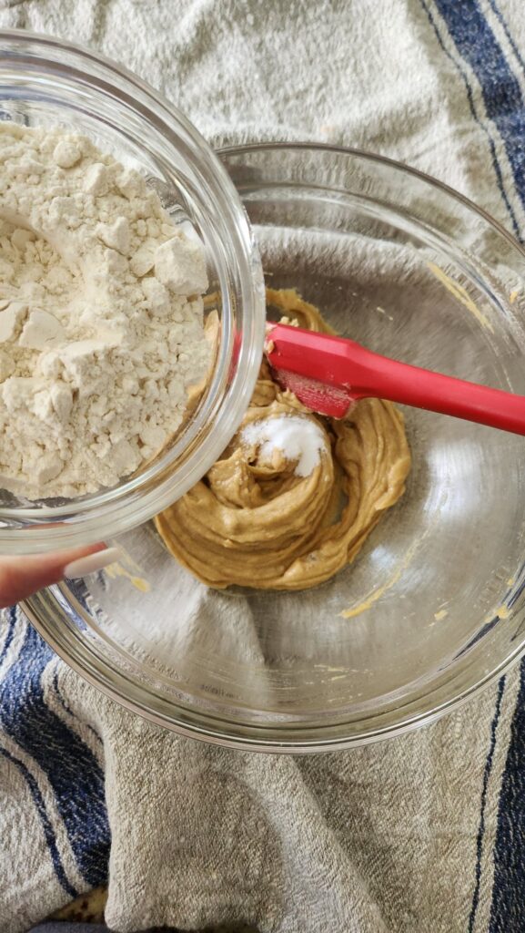 flour being added to creamed mixture