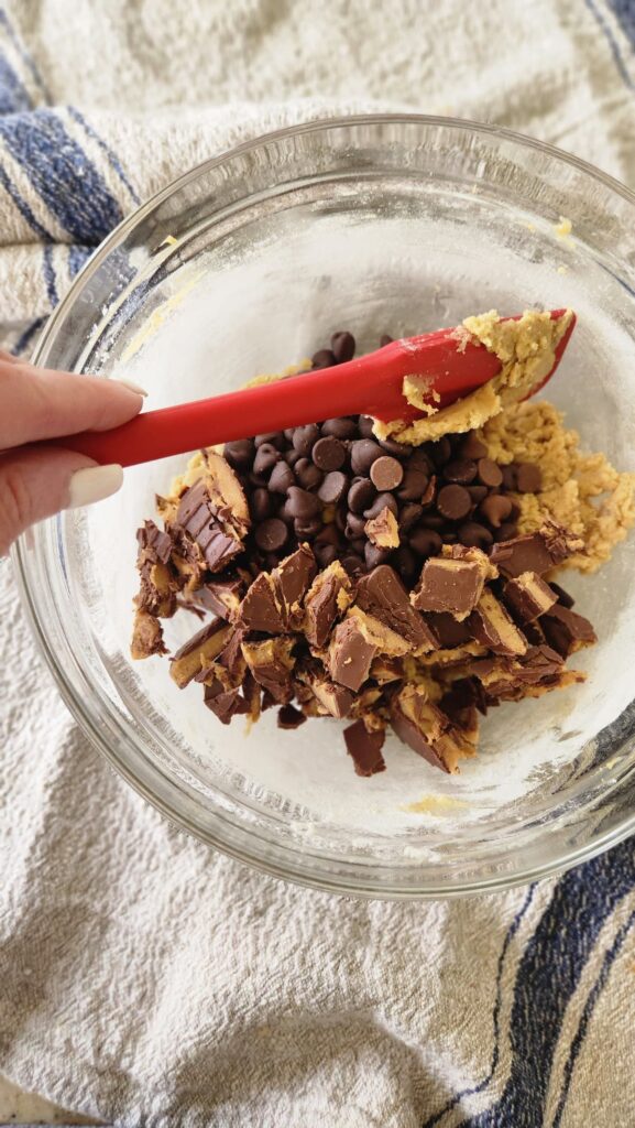 mixing bowl with toffee pieces and chocolate chip being mixed