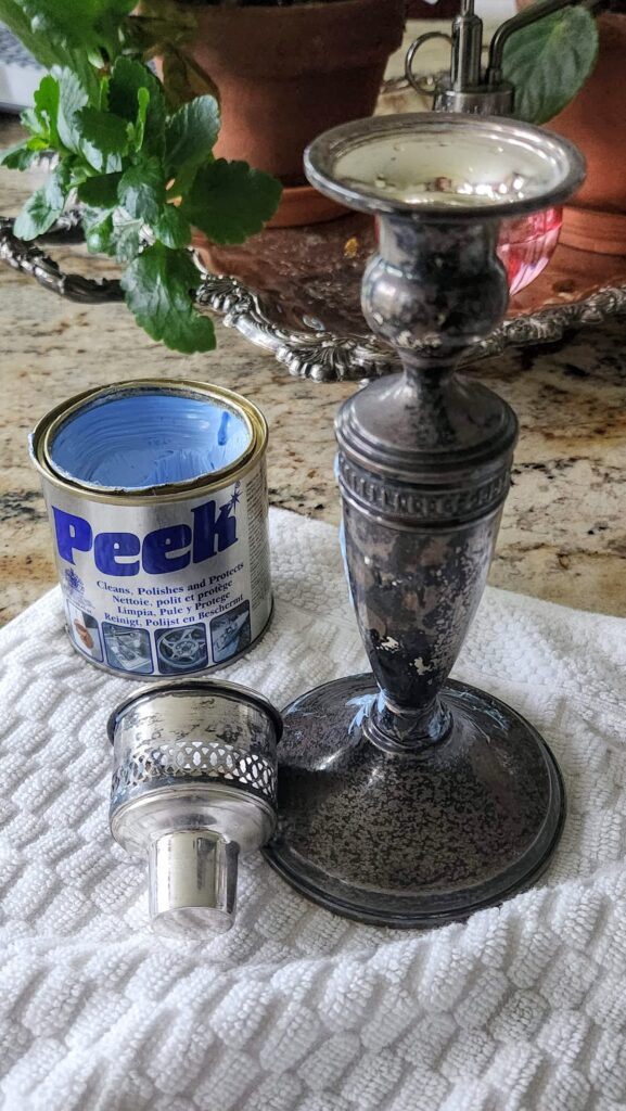 silver candleholder and peek silver polish ready to be polished
