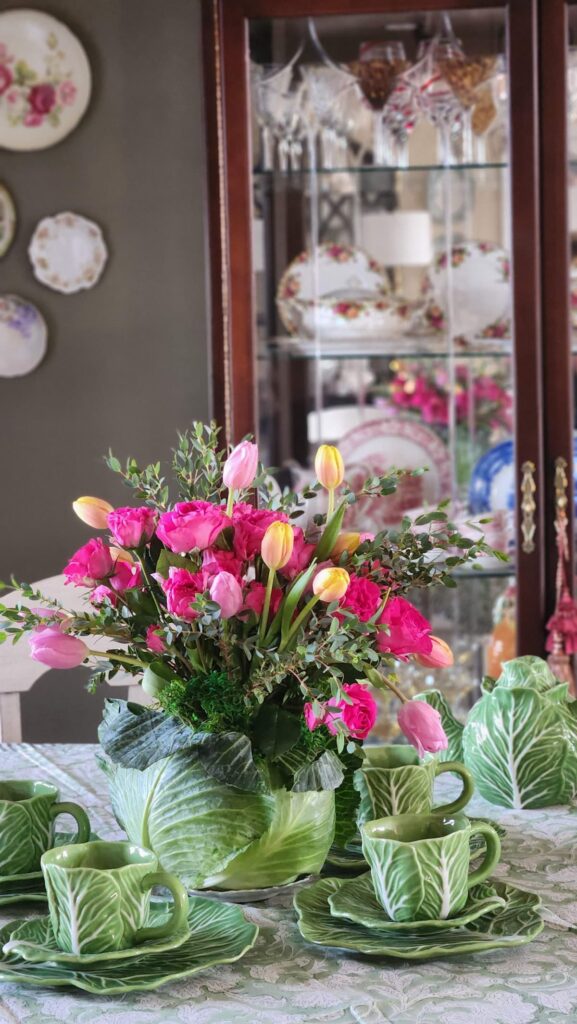 cabbageware dishes with a floral arrangement inside a real cabbage