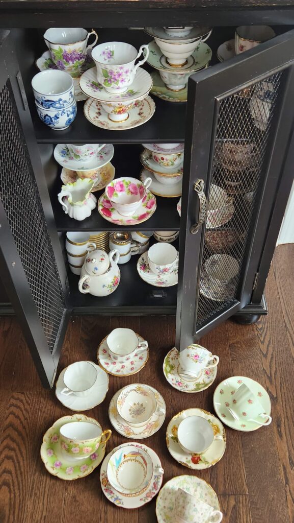 tea cups in cupboard and on the floor. Care Tips and Displaying Your Vintage Items