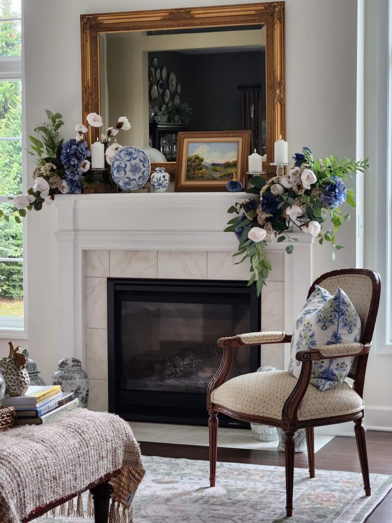 living room mantel with blue florals and vintage items