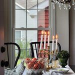 breakfast room table with candles and basket of tomatoes on the table