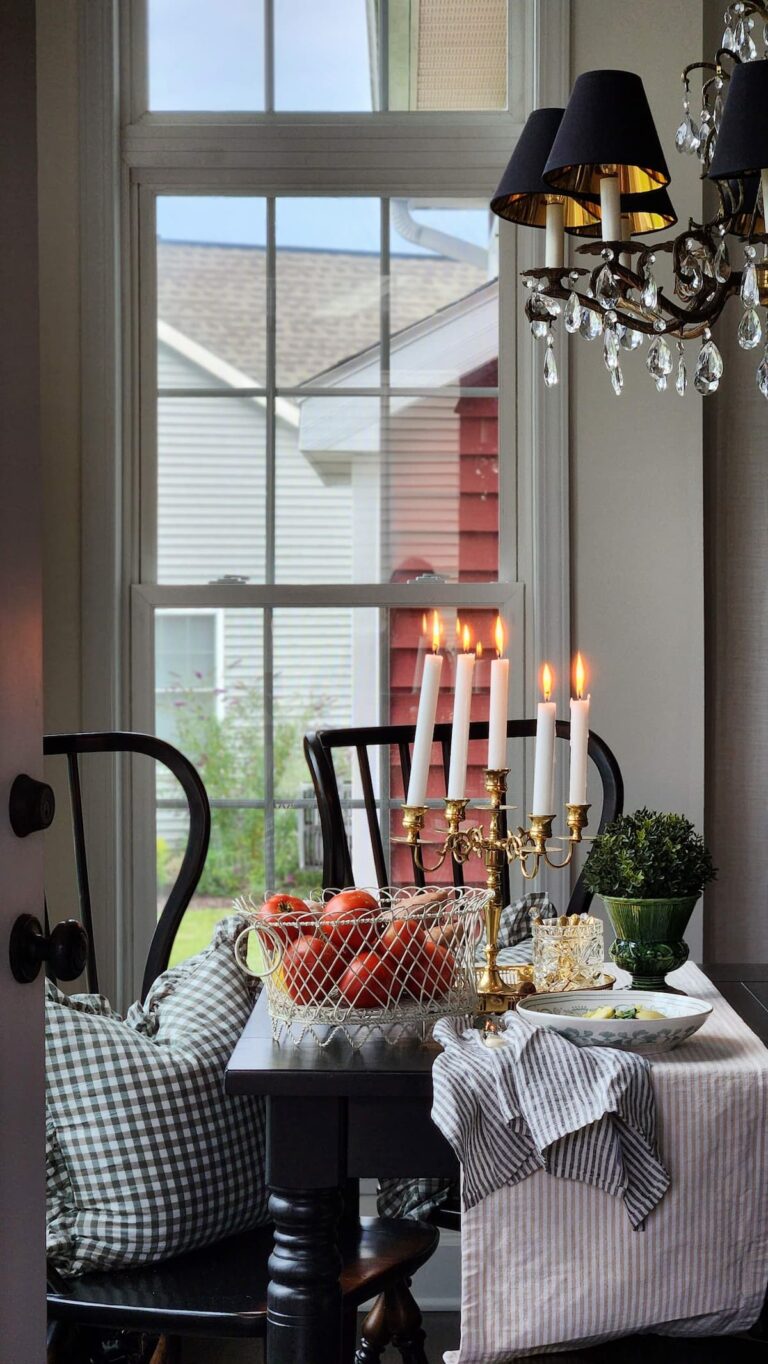 breakfast room table with candles and basket of tomatoes on the table
