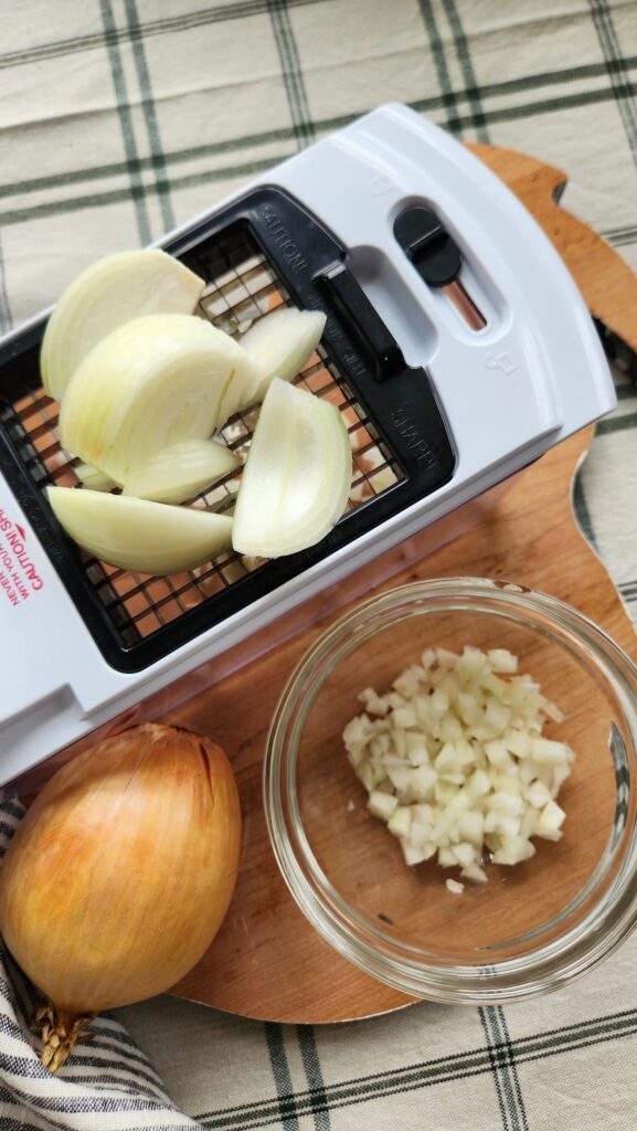 overhead view of onions are garlic being chopped