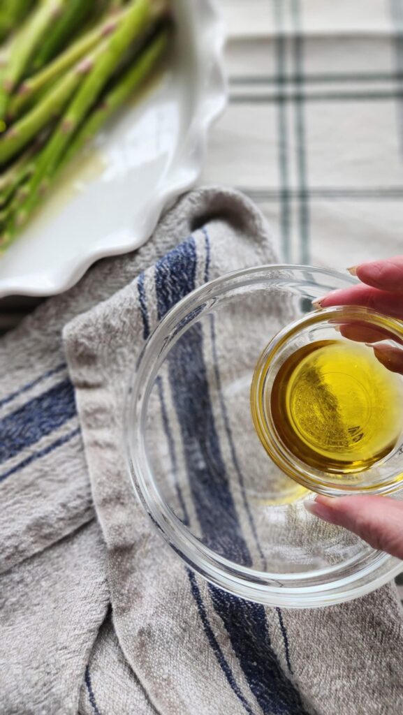 pouring olive oil into small bowl for salmon marinade