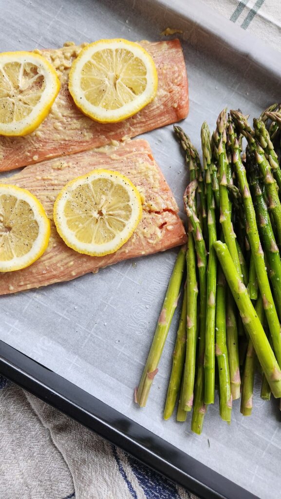 salmon fillets coated in lemon herb marinade ready to bake