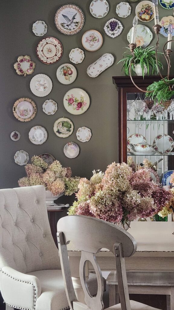 dining room table with plate wall in background