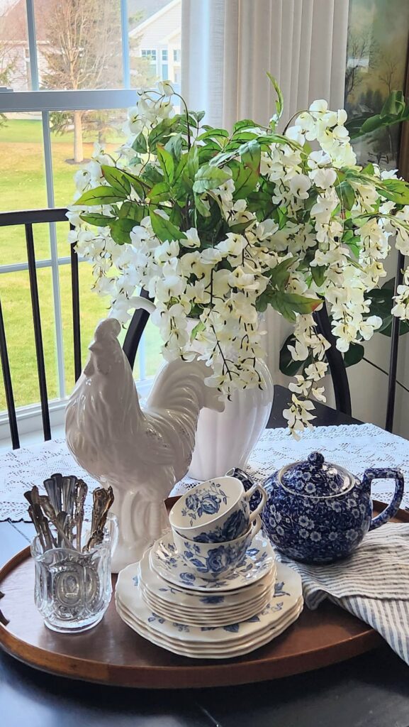 How to style a decorative tray in 10 minutes wooden tray breakfast room white ceramic rooster blue and white Johnson Brothers china chinoiserie teapot silver spoons crystal holder white wisteria French country decor