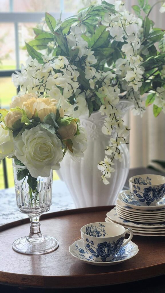 Vintage crystal celery jar with garden florals styled on table