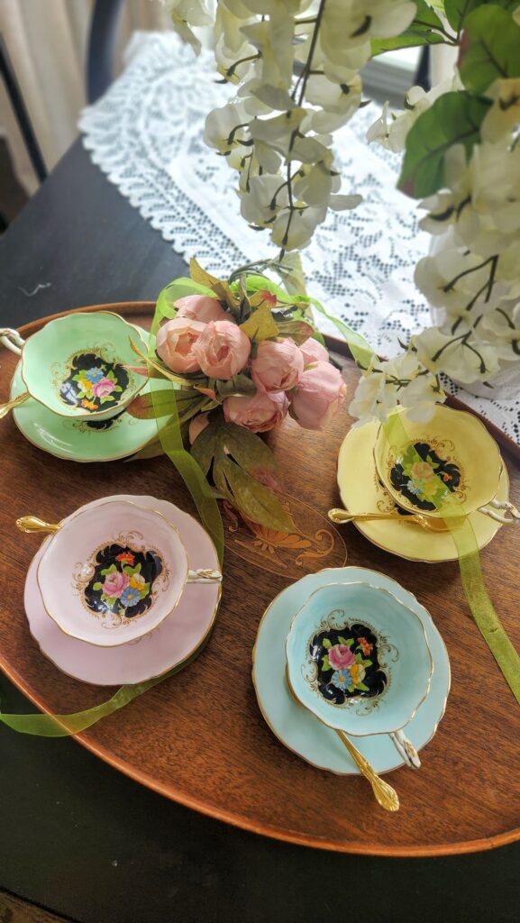 Set of four Paragon bone china teacups in pastel colors on breakfast room table