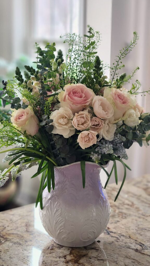 How to arrange spring flowers in a vintage vase finished arrangement wooden tray breakfast room lavender pitcher pink cream roses pussy willow blue and white teacups