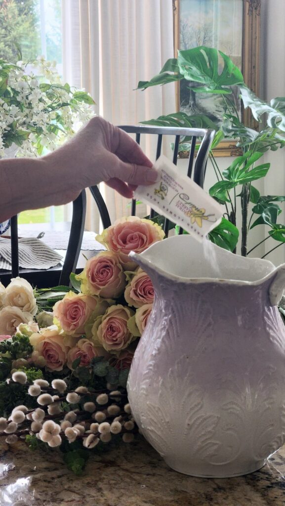 How to arrange spring flowers in a vintage vase adding floral food packet step by step lavender pitcher pink roses fresh flowers counter kitchen