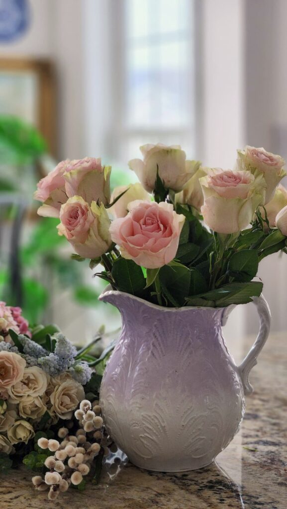 How to arrange spring flowers in a vintage vase step by step pink roses snapdragons lavender pitcher floral snips counter spring arrangement progress