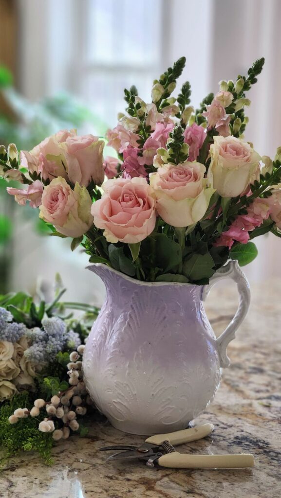 How to arrange spring flowers in a vintage vase step by step snapdragons pink roses added lavender pitcher kitchen counter progress