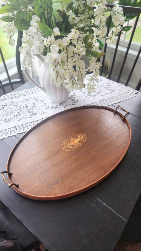 Empty round wooden tray with brass handles breakfast room table styling start