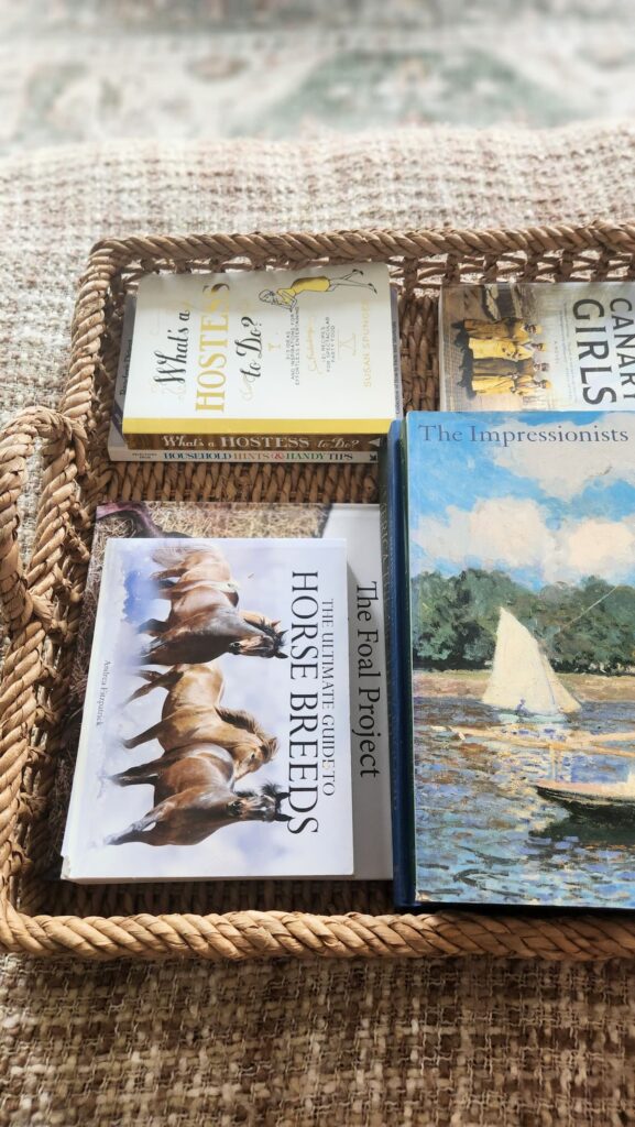 Empty large wicker tray with rope handles on ottoman living room French country home decor