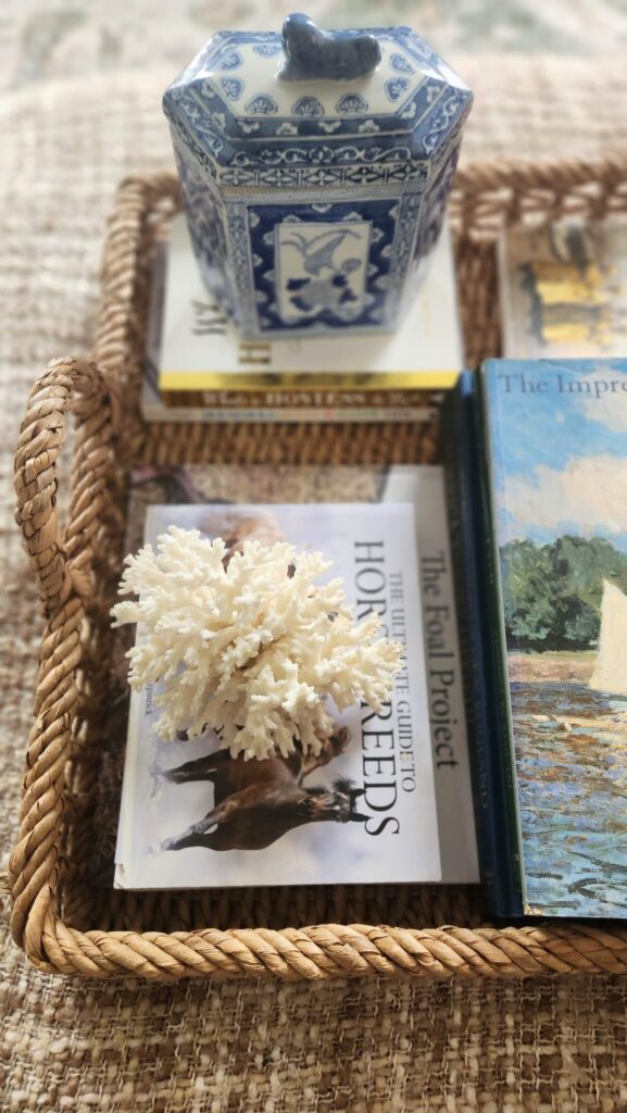 Decorative wicker tray styling progress white coral cream roses coffee table books ottoman living room