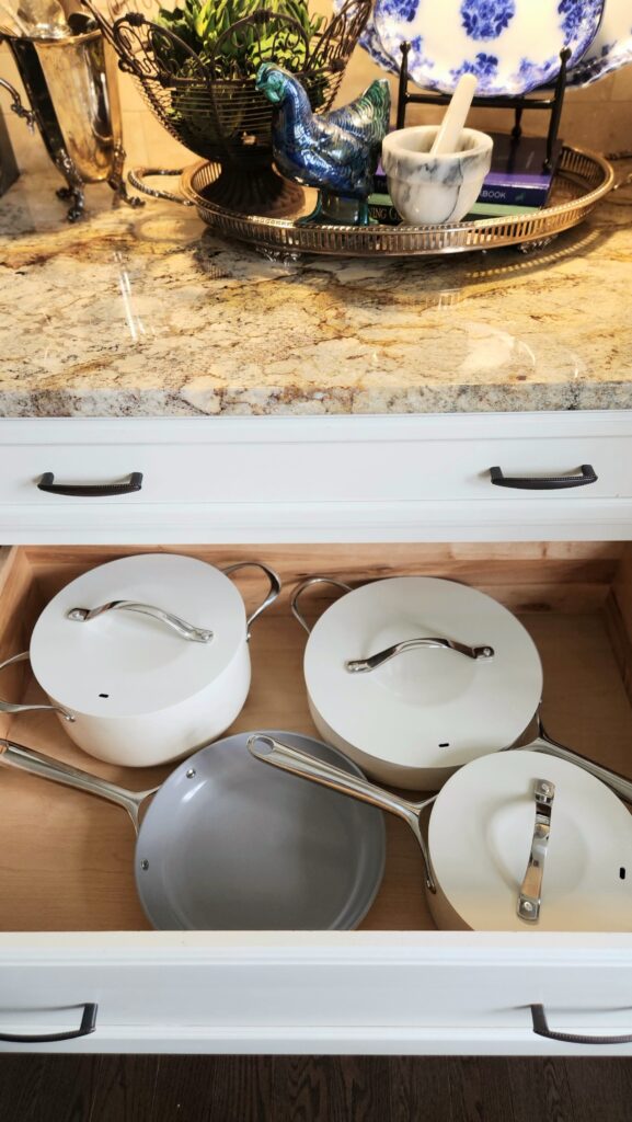 white ceramic skillet and pans in kitchen drawer for mediterranean seafood recipe