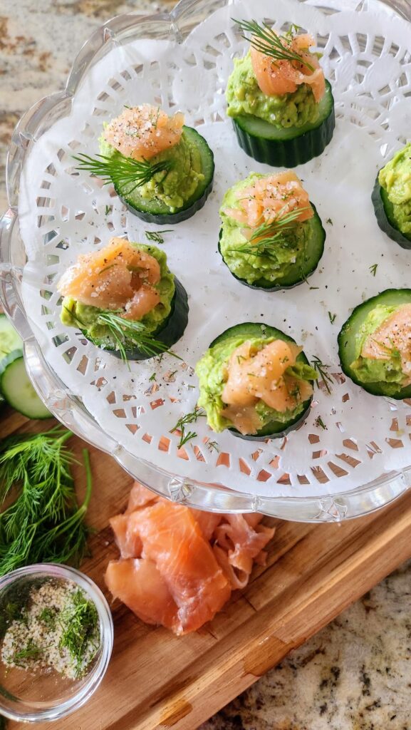 finished easy smoked salmon cucumber bites with fresh dill on crystal cake stand
