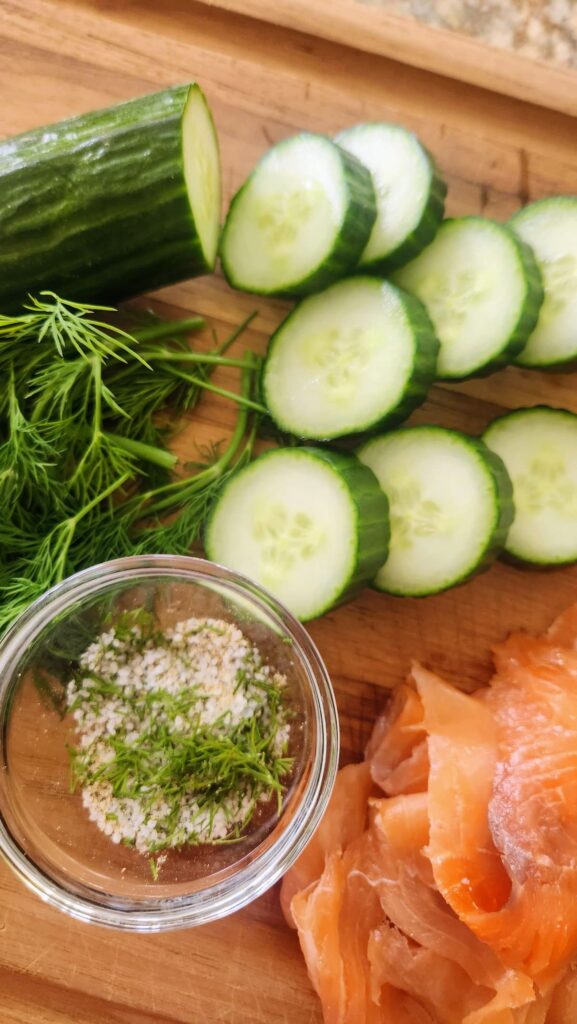 sliced english cucumber rounds with homemade herb salt and smoked salmon for easy appetizer