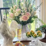 smoked salmon cucumber bites party appetizer styled with pink roses and white rooster on spring table